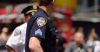 Two NYPD officers, one wearing a blue uniform and one wearing a white one.