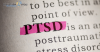 The word PTSD highlighted in pink on a printed page, symbolizing the focus on post-traumatic stress disorder. The Disqualification Appeals logo is displayed in the top left corner, connecting the image to legal assistance for individuals with PTSD seeking law enforcement careers.